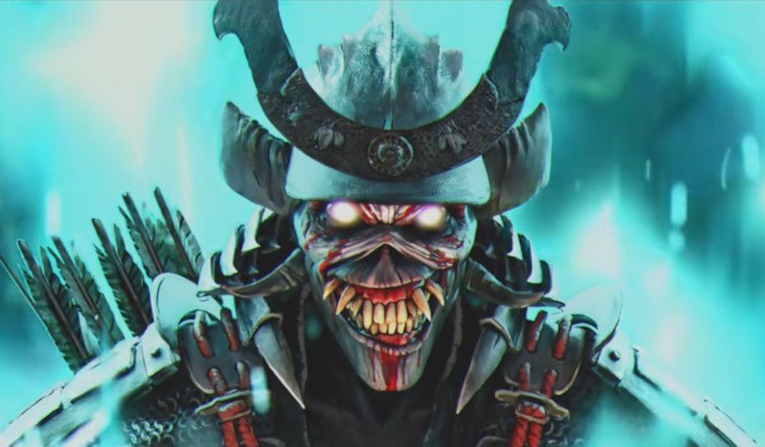 Screenshot eines schelmisch und mit zu vielen Zähnen lächelnden Eddie aus dem Iron Maiden-Musikvideo zu "The Writing On The Wall".